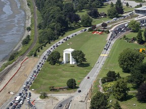 In this July 24, 2009 file photo, cars line-up heading into the United States at left and into Canada at right adjacent to Boundary Bay at a border crossing at Blaine, Wash. (AP Photo/Elaine Thompson)