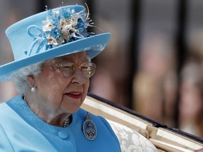 Britain's Queen Elizabeth rides in a carriage to attend the annual Trooping the Colour Ceremony in London, Saturday, June 9, 2018.