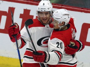 Carolina Hurricanes' Noah Hanifin celebrates his goal against the Ottawa Senators with teammate Sebastian Aho during third period NHL hockey action in Ottawa on March 24, 2018