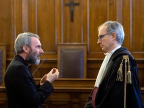 Former Holy See diplomat Monsignor Carlo Alberto Capella, left, talks to his lawyer Roberto Borgogno inside a Vatican tribunal courtroom during his trial, at the Vatican, Saturday, June 23, 2018.