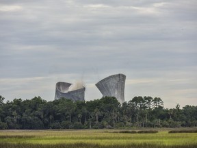 The cooling towers at the St. Johns River Power Park adjacent to the Northside Generating Station are brought down Saturday,  June 16, 2018 in Jacksonville, Fla. The identical towers were imploded simultaneously Saturday morning.  They were the second tallest cooling towers to be imploded in the world.  The St. Johns River Power Park, a 1,264-megawatt, coal-fired electric plant, was closed in January.