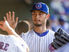 Chicago Cubs' Yu Darvish high fives players during the West Michigan Whitecaps at South Bend Cubs baseball game Monday, June 25, 2018 at Four Winds Field in South Bend, Indiana. (Michael Caterina/South Bend Tribune via AP)