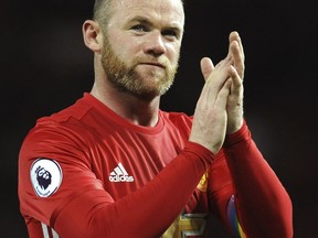 In this Nov. 27, 2016, file photo, Manchester United's Wayne Rooney applauds fans after an English Premier League match against West Ham United in Manchester, England.