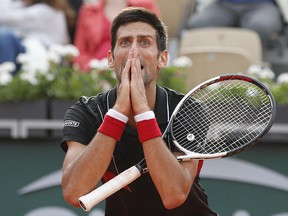 Novak Djokovic reacts after missing a shot against Marco Cecchinato in their quarterfinal match at the French Open at the Roland Garros stadium in Paris, Tuesday, June 5, 2018. (AP Photo/Christophe Ena )