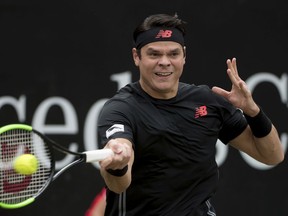 Milos Raonic returns the ball to Roger Federer during the final of the ATP Mercedes Cup in Stuttgart, Sunday June 17, 2018.