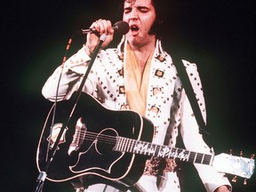 In this 1973 file photo, Elvis Presley sings during a concert.