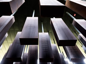 Pillars inscribed with the names of victims of lynching from southern states including North Carolina, Mississippi and Louisiana hang from the ceilings inside the National Memorial for Peace and Justice in Montgomery, Ala. on April 28, 2018. (Evan Frost/Minnesota Public Radio via AP)