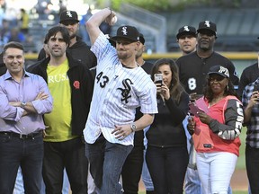 Chicago White Sox pitcher Danny Farquhar (43) throws out the ceremonial first pitch before a game against the Milwaukee Brewers on Friday, June 1, 2018, in Chicago. (AP Photo/David Banks)