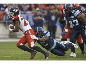 Toronto Argonauts defensive back Jermaine Gabriel (5) misses a tackle on Calgary Stampeders running back Don Jackson (25) during the first half of CFL football game action at BMO Field in Toronto, Ontario on Saturday June 23, 2018.