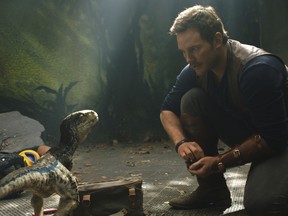 This image released by Universal Pictures shows Chris Pratt in a scene from the upcoming "Jurassic World: Fallen Kingdom."