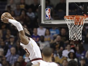 Cleveland Cavaliers' LeBron James goes up to dunk against the Charlotte Hornets during the first half of an NBA basketball game in Charlotte, N.C. on March 28, 2018. (AP Photo/Chuck Burton)