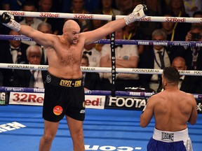 Britain's Tyson Fury (L) and Albania's Sefer Seferi goad each other during their heavyweight contest at the Manchester Arena in Manchester, northern England on June 9, 2018.