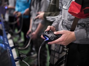 A man plays a game at the Paris Games Week in Paris on Friday, Nov. 3, 2017. (AP Photo/Kamil Zihnioglu)