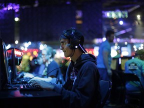 An attendee plays the video game World of Warcraft at the BlizzCon, in Anaheim, Calif., on Nov. 6, 2015.