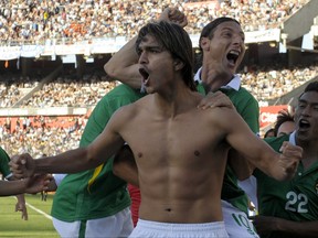 Bolivia's forward Marcelo Martins (without T-shirt) celebrates with teammates after opening the score against Argentina during a Brazil 2014 World Cup South American qualifier match held at the Monumental stadium in Buenos Aires on November 11, 2011. (JUAN MABROMATA/AFP/Getty Images)