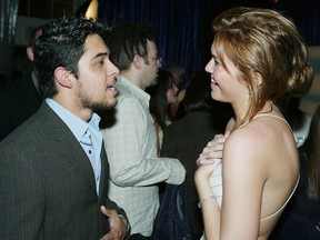 Wilmer Valderrama (L) and Mandy Moore talk at the after-party for United Artists' 'Saved' at the Beverly Hills Community Sports Center on May 13, 2004 in Beverly Hills, California. (Photo by Kevin Winter/Getty Images)