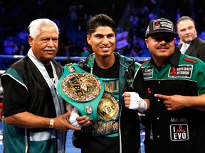 Mikey Garcia (C) poses with members of his camp after knocking out Dejan Zlaticanin in the third round to win the WBC lightweight title at MGM Grand Garden Arena on January 28, 2017 in Las Vegas, Nevada. (Steve Marcus/Getty Images)