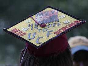 Shannon Recor, a graduate of  Marjory Stoneman Douglas High School,  wears a mortar board where she wrote, 'My human is off to UCF MSD Strong,' after attending the graduation ceremony at the BB&T Center on June 3, 2018 in Sunrise, Florida. (Cait Christenson not pictured)