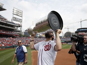 Washington Capitals' Alex Ovechkin, from Russia, kisses the Stanley Cup on the field before a baseball game between the Washington Nationals and the San Francisco Giants at Nationals Park, Saturday, June 9, 2018, in Washington.
