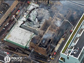 An handout photo taken and released by Police Scotland on June 16, 2018, shows an aerial view of the smoldering roof of Glasgow School of Art. (POLICE SCOTLAND/HO/AFP/Getty Images)