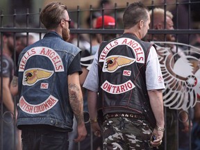 Members of the Hells Angels from British Columbia and Ontario enter the Hells Angels Nomads compound during the group's Canada Run event in Carlsbad Springs, Ont., near Ottawa, on Saturday, July 23, 2016.