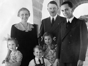 A picture taken in Hitler's eagle nest in Berchtesgaden on Oct. 25, 1938 shows Joseph Goebbels (R), Third Reich Minister of Propaganda, posing with his wife Magda and three of his children, and German Chancellor Adolf Hitler (C).