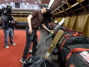 Senators winger Alex Burrows places his hockey sticks with his belongings in the locker room after speaking to reporters during the team's season wrap-up on April 9.