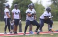 Argonauts’ offensive lineman Tyler Holmes (centre) works out during practice at York University. (Jack Boland/Toronto Sun)