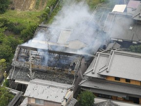 Smoke rises from a house blaze in Takatsuki, Osaka, following an earthquake Monday, June 18, 2018.