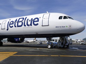 In this March 16, 2017, file photo, a JetBlue airplane is seen at John F. Kennedy International Airport in New York. (AP Photo/Seth Wenig, File)