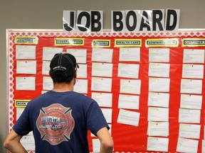 Jordan Vandermeer, looks over the job board in the Employment Resource Centre in Sarnia, Ont., on Aug. 25, 2017.