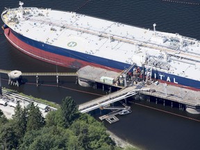 A aerial view of Kinder Morgan's Trans Mountain marine terminal filling a oil tanker in Burnaby, B.C., is shown on Tuesday, May 29, 2018. Kinder Morgan Canada is paying $1.5-million bonuses to two senior executives to ensure they stay with the company as its Trans Mountain pipeline system is sold to the federal government under a $4.5-billion sales agreement.
