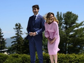 Prime Minister Justin Trudeau and wife Sophie Gregoire Trudeau wait to greet the leaders at the official welcoming ceremony at the G7 Leaders Summit in La Malbaie, Que., on Friday, June 8, 2018.