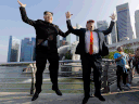 Kim Jong Un and Donald Trump impersonators, Howard X, left, and Dennis Alan, jump together as they pose for photographs at Merlion Park, a popular tourist destination in Singapore, on Friday, June 8, 2018.