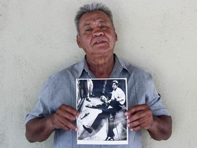 In this undated photo provided by StoryCorps, Juan Romero, 67, holds a photo of himself and the dying Sen. Robert F. Kennedy at the Ambassador Hotel in Los Angeles, taken by the Los Angeles Times' Boris Yaro on June 5, 1968, at his home in Modesto, Calif.