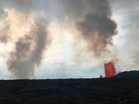 This image obtained June 2, 2018 from the U.S. Geological Survey shows a view from the intersection of Nohea and Leilani Streets at 10:15AM HST on June 1, 2018, the Fissure 8 lava fountain (R) appears to have decreased in height from previous sustained heights of 260 feet (79 metres).