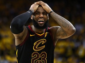 LeBron James of the Cleveland Cavaliers reacts against the Golden State Warriors in Game 1 of the 2018 NBA Finals at ORACLE Arena on May 31, 2018