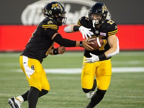 Hamilton Tiger-Cats quarterback Jeremiah Masoli hands the ball off to Hamilton Tiger-Cats running back Mercer Timmis during second half CFL game action against the Winnipeg Blue Bombers in Hamilton on Friday, June 29, 2018.