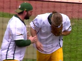 Green Bay Packers star Clay Matthews is checked on by offensive lineman Lucas Patrick after hitting him with a line drive in a charity softball game. (YouTube screen grab)