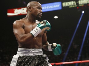 In this Sept. 12, 2015, file photo, Floyd Mayweather Jr. fights Andre Berto during their welterweight title bout in Las Vegas. (AP Photo/Steve Marcus, File)