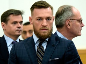 Mixed martial arts fighter Conor McGregor, centre, arrives at Brooklyn Supreme Court, Thursday, June 14, 2018, in New York.
