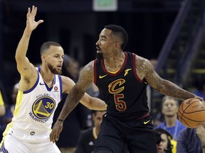 Cleveland Cavaliers guard J.R. Smith (5) is defended by Golden State Warriors guard Stephen Curry (30) during Game 1 of the NBA Finals in Oakland, Calif., Thursday, May 31, 2018.