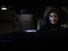 Hessah al-Ajaji sits in her car on the capital's busy Tahlia Street after driving for the first time in Riyadh, Saudi Arabia, Sunday, June 24, 2018.
