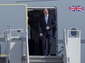 Britain's Prince William disembarks from a Royal Air Force plane after landing at the Marka airport in Amman, Jordan, Sunday, June 24, 2018.