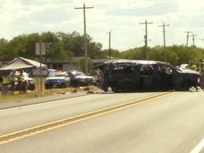 This frame grab from video provided by KABB/WOAI in San Antonio shows the scene where authorities say at least five people are dead and several others hurt as an SUV carrying more than a dozen people crashed, Sunday, June 17, 2018, in Big Wells, Texas, while fleeing from Border Patrol agents.