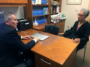 In this Thursday, May 24, 2018 photo, Adine Usher, 78, meets with breast cancer study leader Dr. Joseph Sparano at the Montefiore and Albert Einstein College of Medicine in the Bronx borough of New York. Usher was one of about 10,000 participants in the study which shows women at low or intermediate risk for breast cancer recurrence may safely skip chemotherapy without hurting their chances of survival.