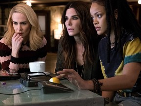 This image released by Warner Bros. shows Sarah Paulson, from left, Sandra Bullock and Rihanna in a scene from 'Ocean's 8.' (Barry Wetcher/Warner Bros. via AP)