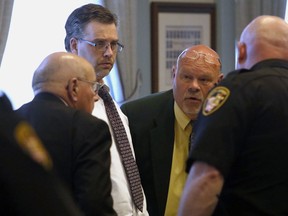 In this May 7, 2018, file photo, Shawn Grate, centre left, listens to his attorneys Robert Whitney, left, and Rolf Whitney during a trial in Ashland, Ohio.