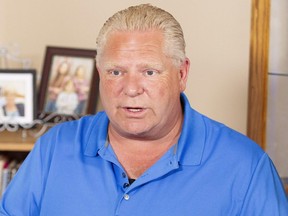 Ontario Progressive Conservative leader Doug Ford at a campaign stop in the kitchen of Bill and Linda Reid in Reeces Corners, Ont. on Wednesday. (Geoff Robins/The Canadian Press)