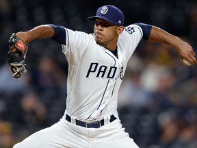In this Sept. 19, 2017, file photo, San Diego Padres relief pitcher Jose Torres winds up during the ninth inning of a baseball game against the Arizona Diamondbacks in San Diego